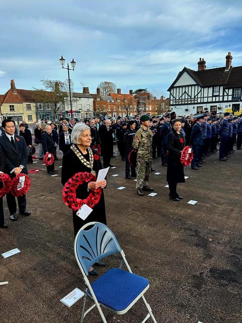 Remembrance Sunday parade in Beaconsfield Old Town: wreath-bearers, cadets and the town mayor in chain lined up on the square