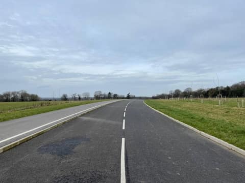 Empty unfinished Relief Road across open land