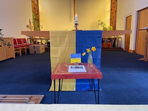 Altar table draped in Ukrainian colours with daffodils