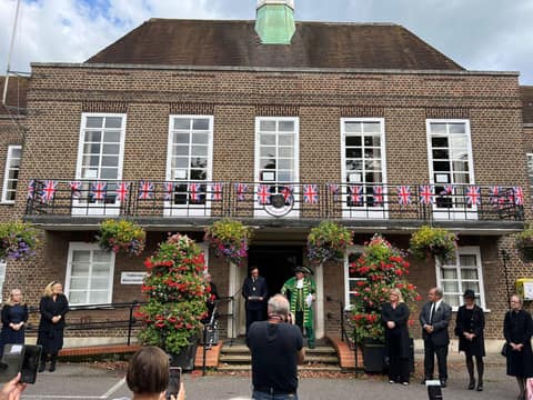 Beaconsfield Town Hall with bunting and the town crier on the steps as the Proclamation is read