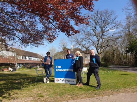 Campaigners beside a Vote Conservative board on the Town Green