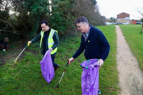 Jackson in hi-vis litter picking with a fellow councillor on Holtspur Park grass