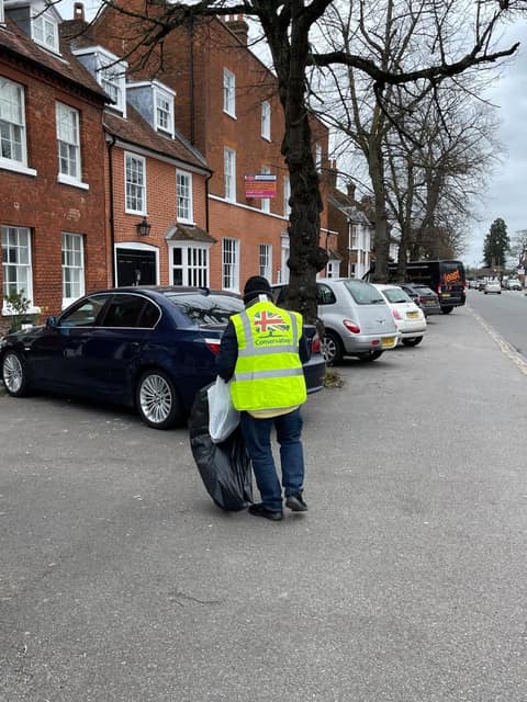 Volunteer in hi-vis litter picking in Old Town