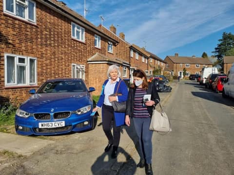 Two campaigners walking along a residential street