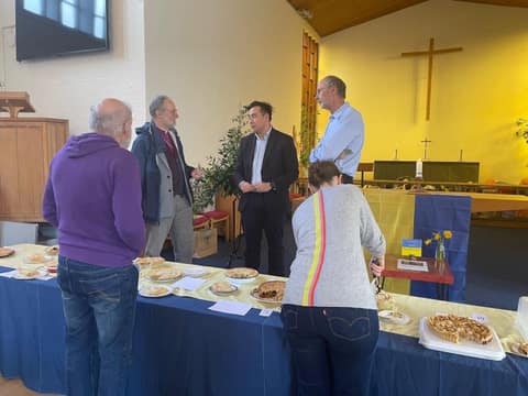 Jackson judging with other judges beside the pie table in the church